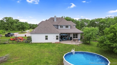 Back of house with a patio, roof with shingles, st