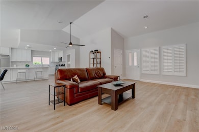 Living area featuring light wood-style floors, cei