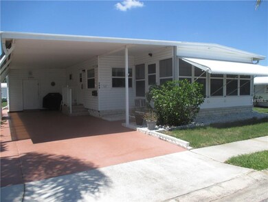 Extra wide covered car port with attached utility 