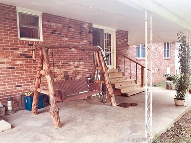Brick home with large covered patio overlooking ba