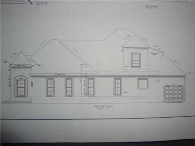 Photo. This side elevation shows the garage enteri
