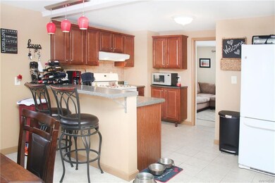 Kitchen with breakfast bar, open to dining room, u