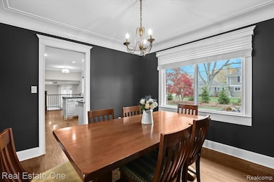 Dining area featuring wood finished floors and a chandelier