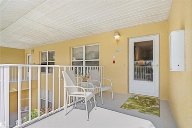 Property entrance featuring a balcony and stucco s
