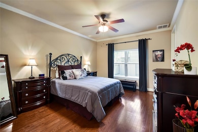 Bedroom with crown molding, a ceiling fan, basebo