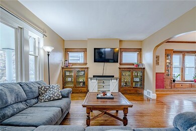 The large living space is lit by a beautiful picture window.