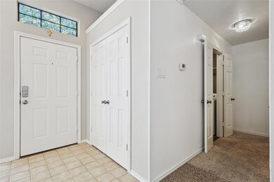Entryway with light tile patterned flooring