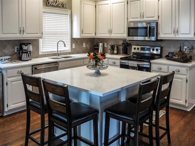 kitchen features spacious island and quartz counte