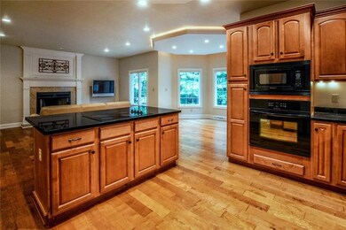 Kitchen boasts abundant maple cabinets, granite co