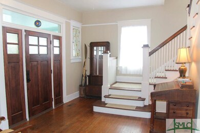 Foyer area with beautiful staircase.