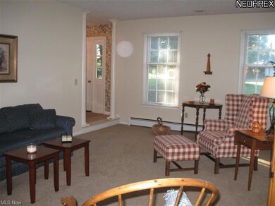 Another view of living room with neutral, new carpeting.
