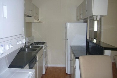 Kitchen with under cabinet range hood, white appl