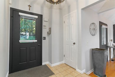 The welcoming foyer has a tile floor and coat closet.
