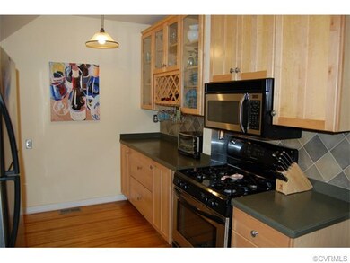 Kitchen: 137 x 910 Hardwood floors, Corian counter