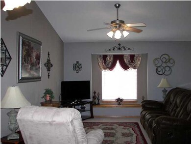 The living room is spacious with vaulted ceilings 