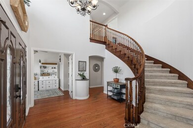 Double door entrance, sweeping stair case...door straight right is downstairs bedroom currently used as an office...door to right leads to dinette, kitchen, laundry and Garage