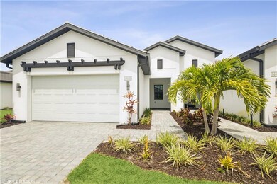 View of front of house with stucco siding, decorative driveway, and an attached garage