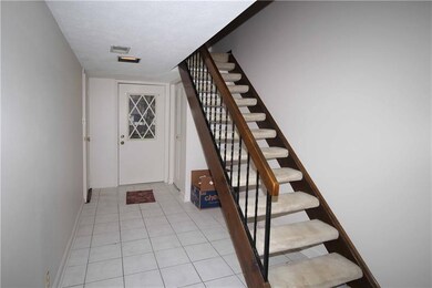 Front Door Entrance With Ceramic Tile Flooring* The Stairs Lead to the Main Living Areas* The Little Doorknob That's Barely Visible on the Left Is The Door To The Garage*