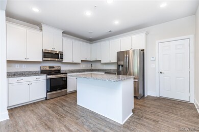 Kitchen with range oven, refrigerator, microwave,