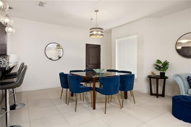 Tiled dining room featuring an inviting chandelier