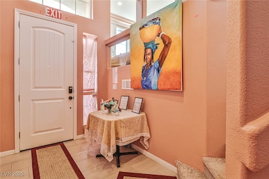 Tiled foyer with baseboards
