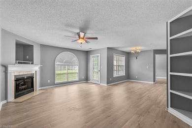 Open floorplan with large windows, updated flooring, built-in shelves and fireplace!