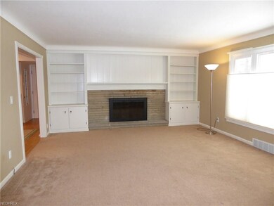 Newly carpeted Living Room has a stone fireplace a
