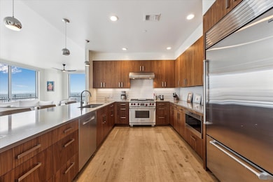 Kitchen featuring visible vents, a sink, built in
