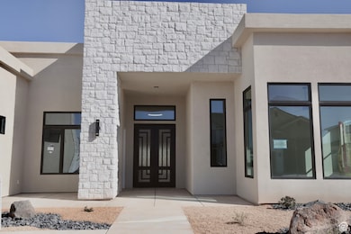View of exterior entry featuring stucco siding