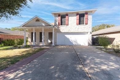 View of front facade featuring stone siding, a porch, concrete driveway, an attached garage, and a front lawn
