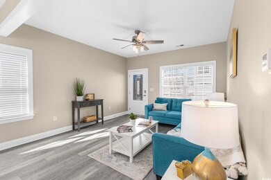Living room with ceiling fan, wood finished floors