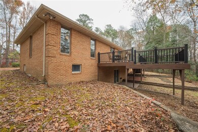 View of side of home featuring a wooden deck