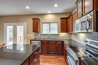 Enjoy the view from the kitchen sink to the wooded backyard!