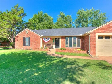 Ranch-style house with a garage and a front lawn
