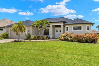 View of front of property featuring a garage and a front lawn