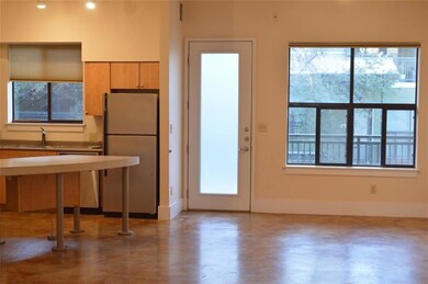 Kitchen featuring freestanding refrigerator, stai