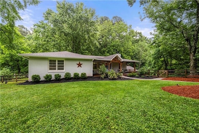 View of front of home featuring covered porch, brick siding, and roof with shingles