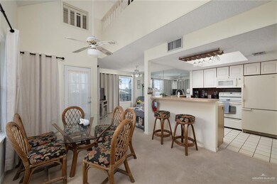 Dining space featuring light carpet, ceiling fan, light tile patterned floors, and visible vents