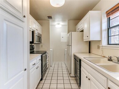 Kitchen has a utility area with washer and dryer w
