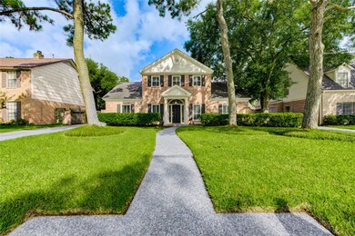 Towering oaks and pines embrace this beautiful hom