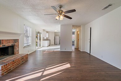 Unfurnished living room featuring ceiling fan, a h