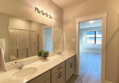 Bathroom with wood finished floors, double vanity