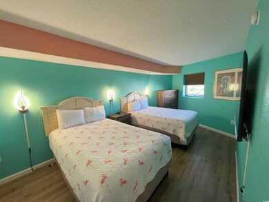 Bedroom with a textured ceiling and dark wood-type flooring