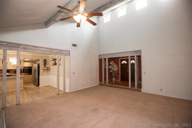 Family Room has soaring ceiling and windows