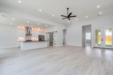 Kitchen with wall chimney range hood, stainless s