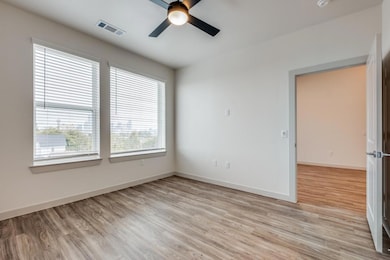 Empty room featuring light hardwood / wood-style f