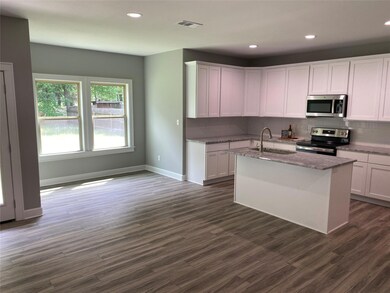 Kitchen with dark hardwood / wood-style floors, si