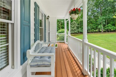 Wooden deck featuring covered porch and a yard
