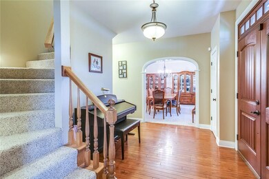 The spacious entryway provides a warm welcome as y