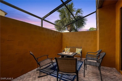 Screened in lanai at dusk featuring a fire pit.